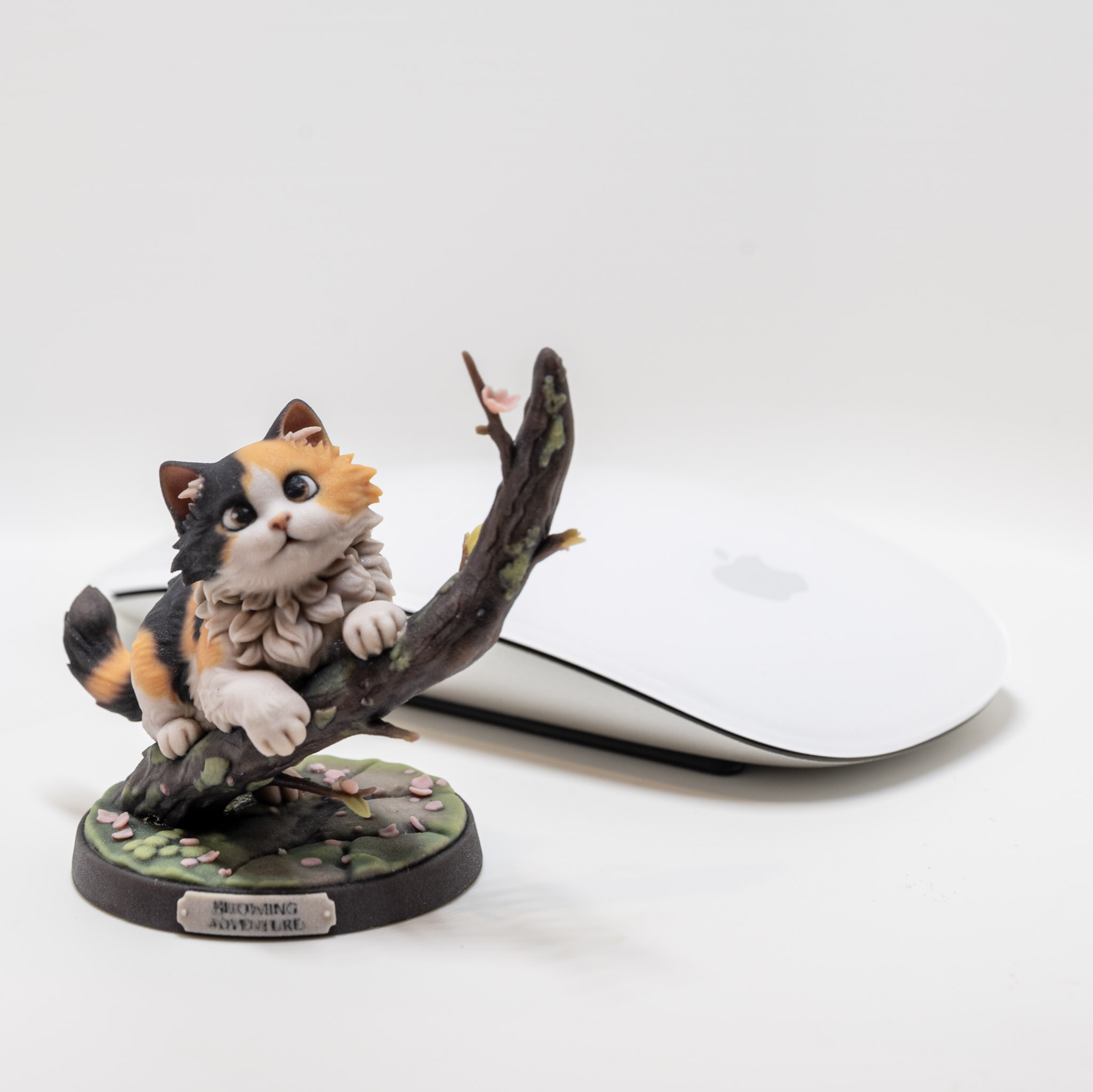 Full-color cat character figurine on a branch